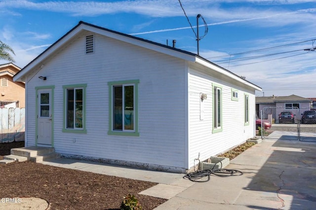 view of property exterior with a patio area