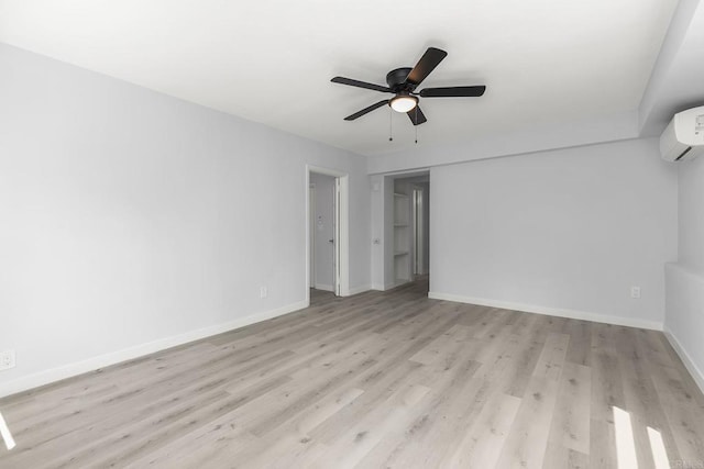 interior space with light hardwood / wood-style flooring, ceiling fan, and a wall unit AC