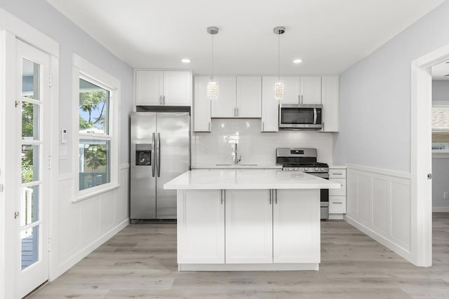 kitchen featuring white cabinetry, appliances with stainless steel finishes, and light hardwood / wood-style flooring