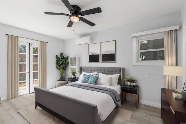 bedroom featuring an AC wall unit, ceiling fan, access to outside, and light wood-type flooring