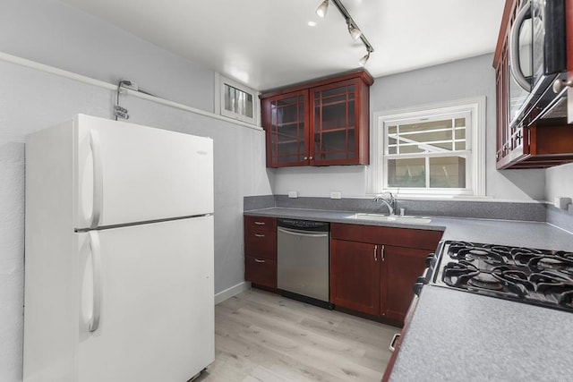 kitchen with light hardwood / wood-style floors, sink, and appliances with stainless steel finishes