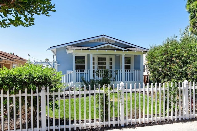 view of front of home with a porch and a front lawn