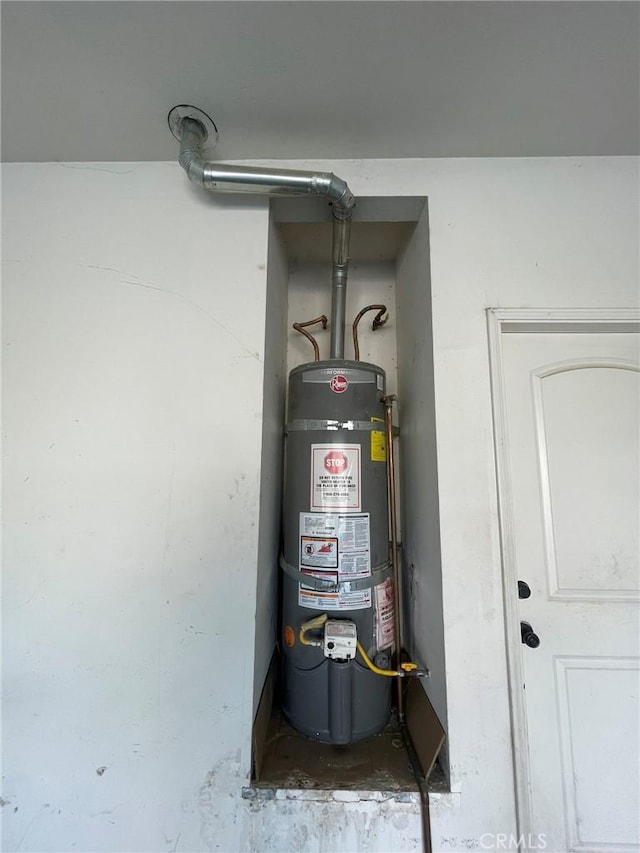 utility room with strapped water heater