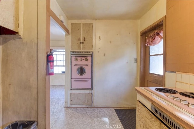 kitchen featuring cream cabinetry, wall oven, and cooktop