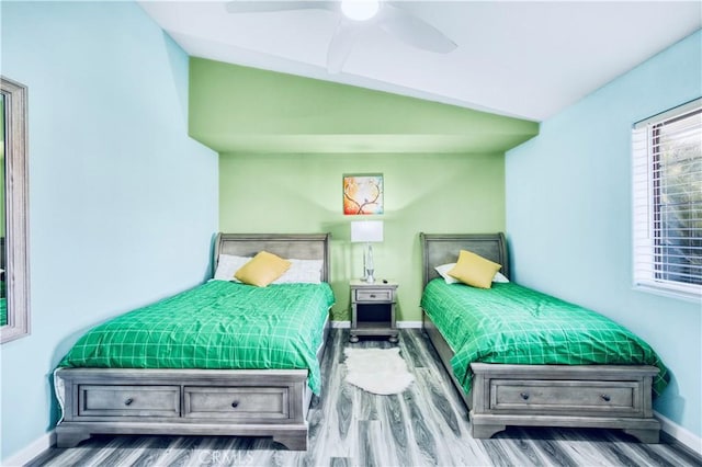 bedroom featuring hardwood / wood-style floors, ceiling fan, and lofted ceiling