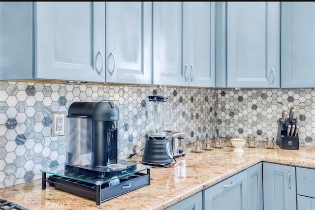 kitchen with tasteful backsplash and light stone countertops