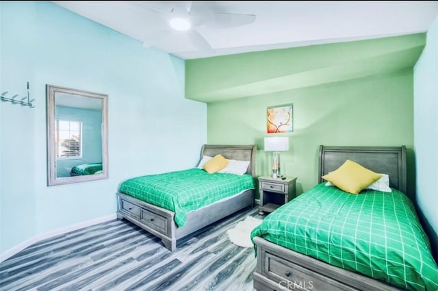 bedroom featuring ceiling fan, wood-type flooring, and lofted ceiling