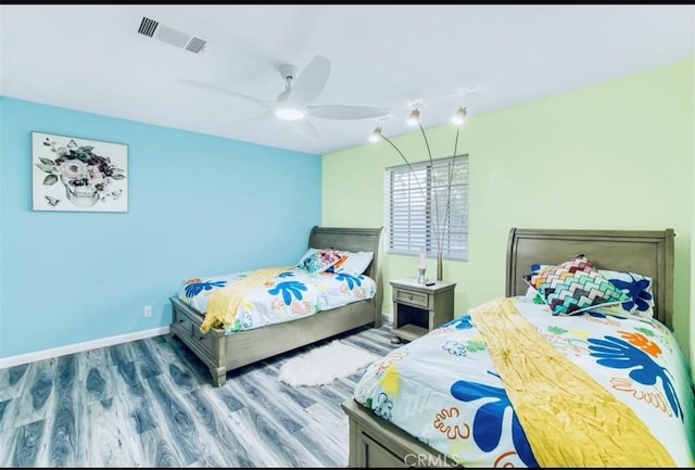 bedroom with ceiling fan and dark hardwood / wood-style flooring