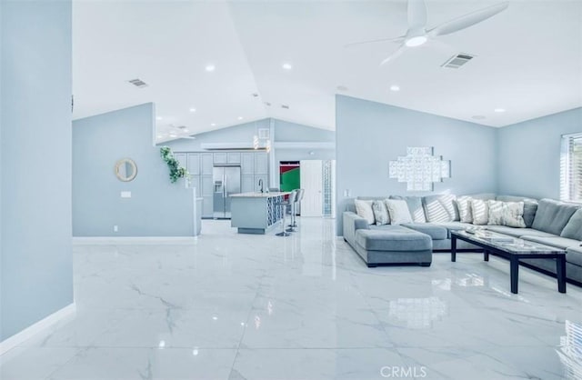 living room with ceiling fan and vaulted ceiling