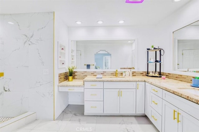 bathroom featuring decorative backsplash, vanity, and walk in shower