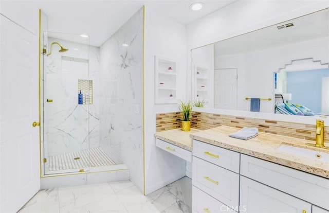 bathroom with tasteful backsplash, vanity, and tiled shower