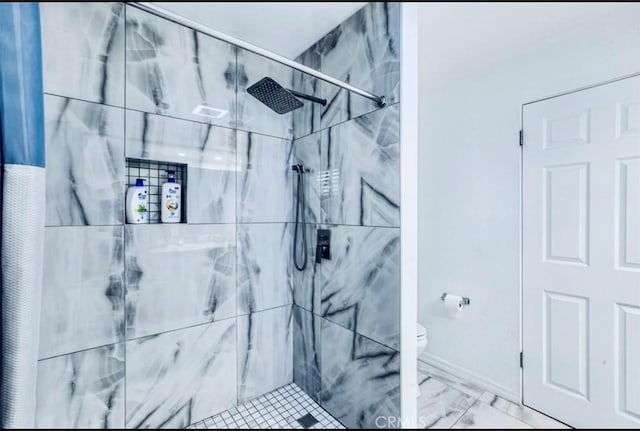 bathroom featuring toilet and tiled shower