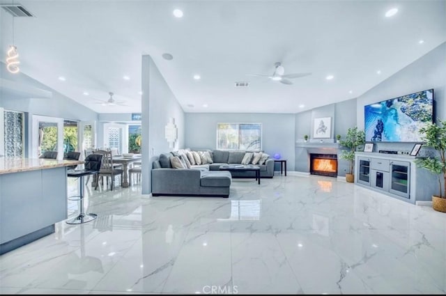 living room featuring ceiling fan and vaulted ceiling