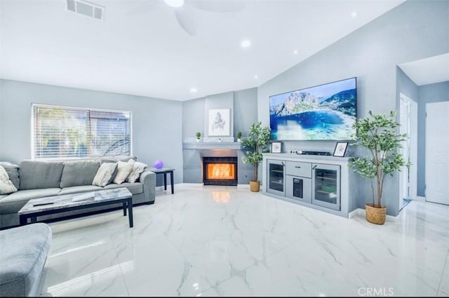 living room with ceiling fan and lofted ceiling