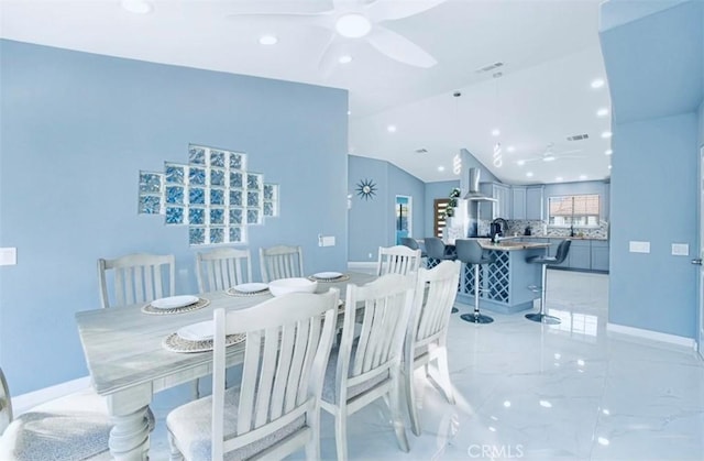 dining area with vaulted ceiling and ceiling fan