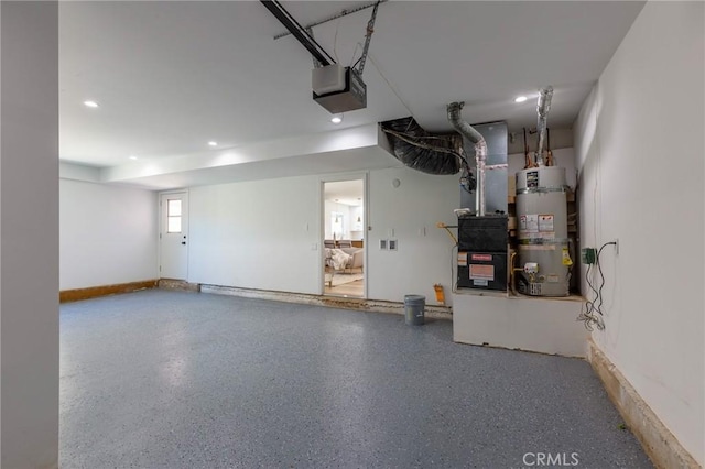 garage with strapped water heater and a garage door opener