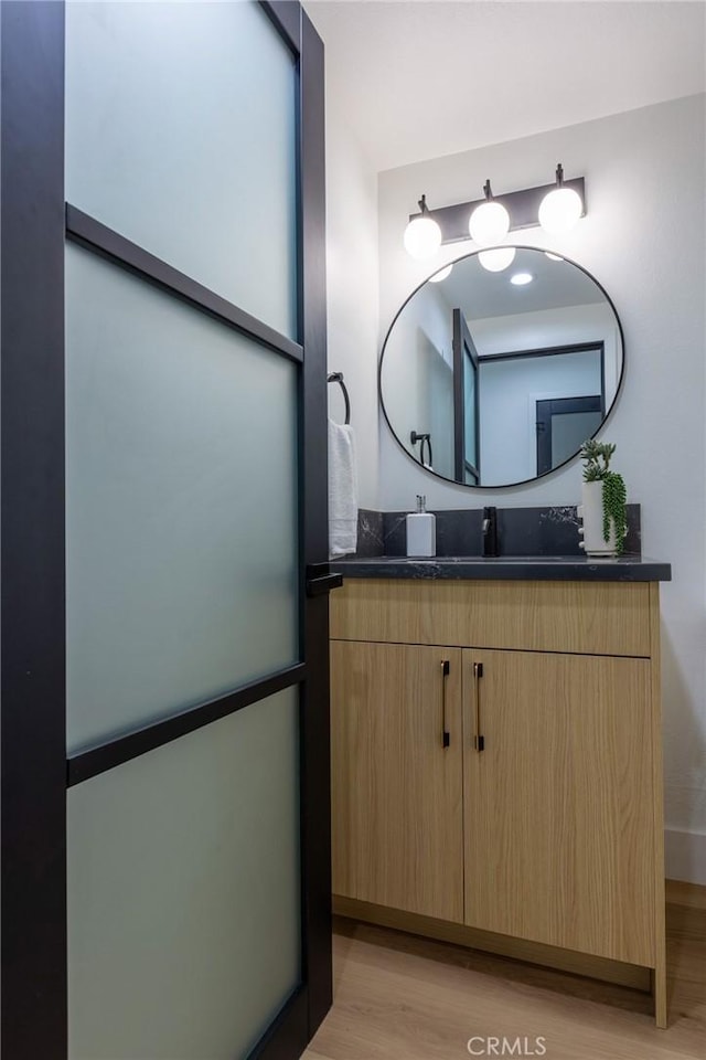 bathroom featuring vanity and hardwood / wood-style flooring