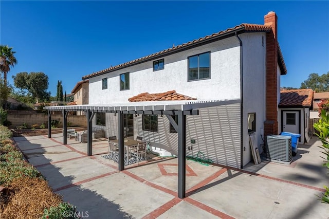 rear view of house with a patio and central AC unit