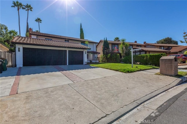 view of front of property featuring a front yard and a garage