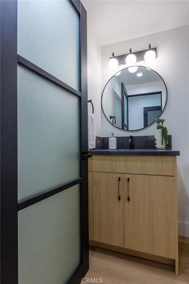 bathroom featuring vanity and hardwood / wood-style flooring