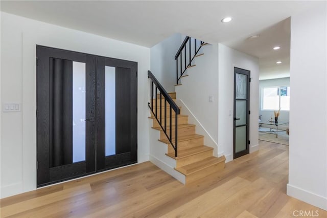 entrance foyer featuring french doors and light hardwood / wood-style flooring