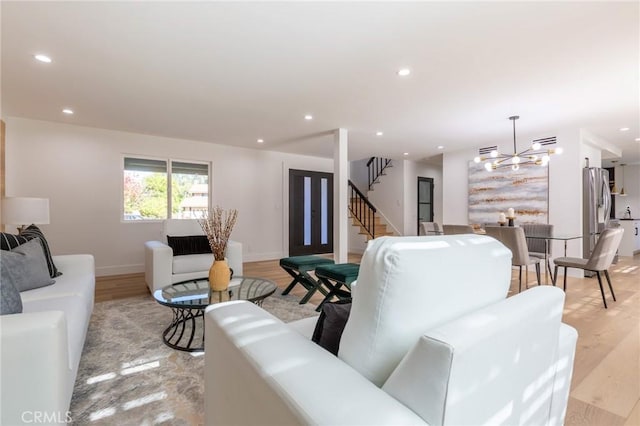 living room featuring a notable chandelier and light hardwood / wood-style floors