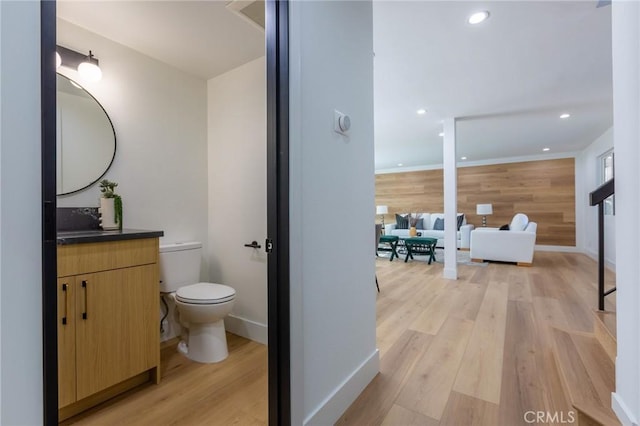 bathroom featuring vanity, toilet, and wood-type flooring