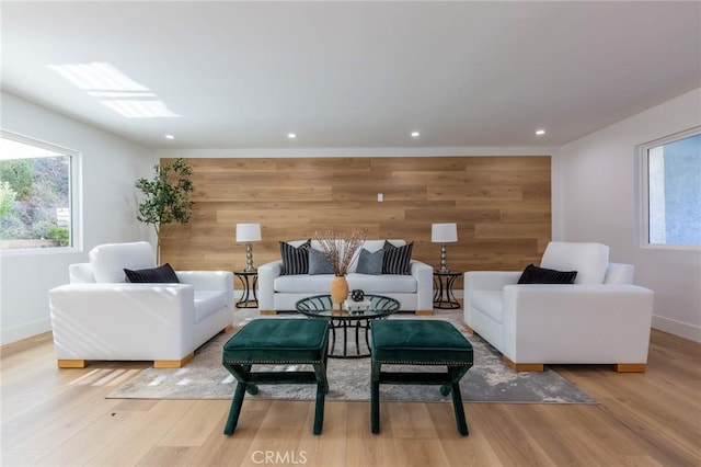 living room featuring light hardwood / wood-style flooring and wooden walls