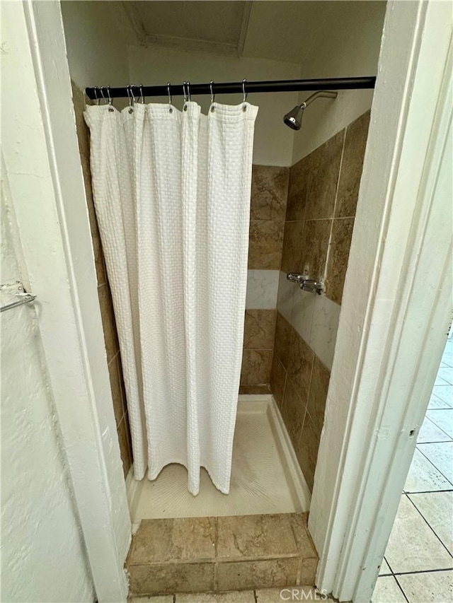 bathroom featuring tile patterned floors and curtained shower