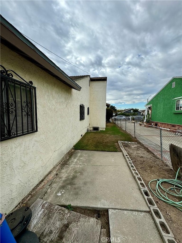 view of side of home with a patio area