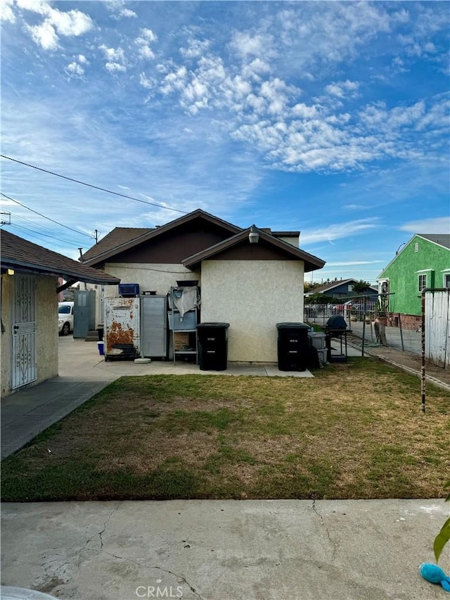 view of side of home featuring a lawn