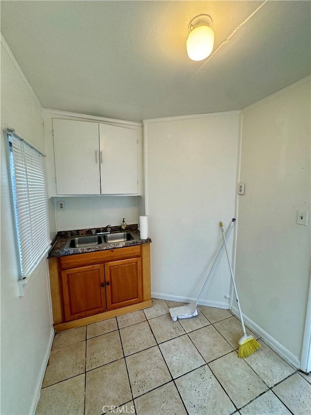 kitchen featuring light tile patterned floors and sink