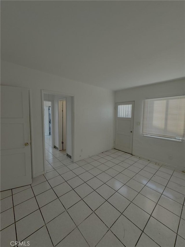 empty room with light tile patterned floors