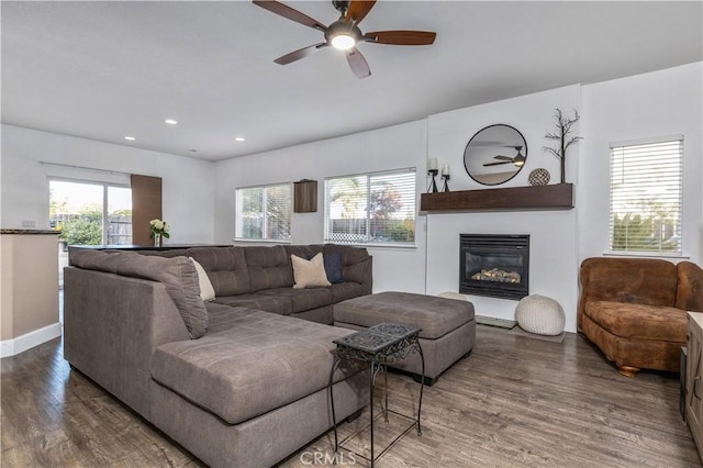 living room with ceiling fan, dark hardwood / wood-style flooring, and a healthy amount of sunlight