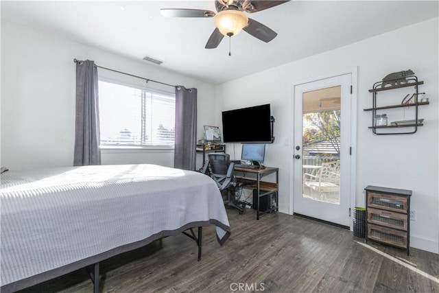 bedroom with access to outside, ceiling fan, dark hardwood / wood-style flooring, and multiple windows