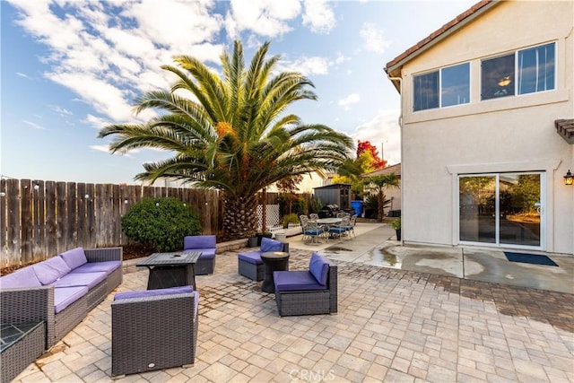 view of patio / terrace featuring an outdoor living space with a fire pit
