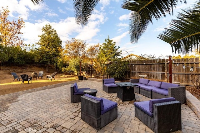 view of patio / terrace with an outdoor living space with a fire pit