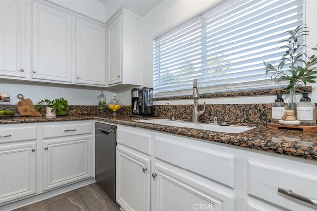 kitchen with sink, white cabinets, dishwasher, and dark stone countertops