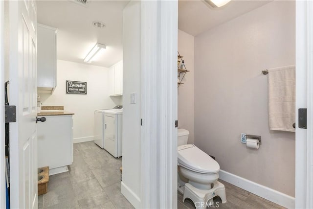 bathroom featuring toilet, vanity, and independent washer and dryer
