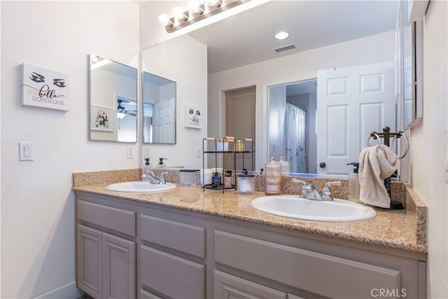 bathroom with ceiling fan and vanity