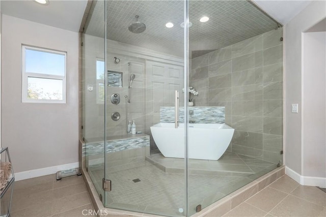 bathroom with separate shower and tub and tile patterned flooring