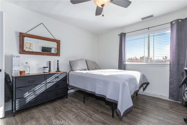 bedroom featuring ceiling fan and dark wood-type flooring