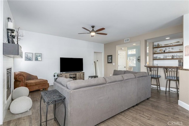 living room with ceiling fan and hardwood / wood-style flooring