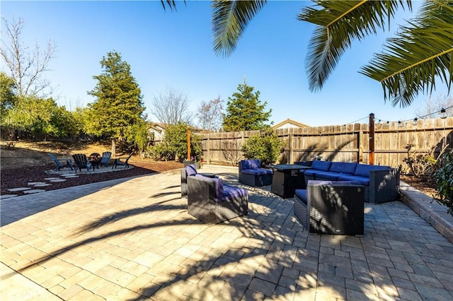 view of patio / terrace featuring an outdoor living space with a fire pit
