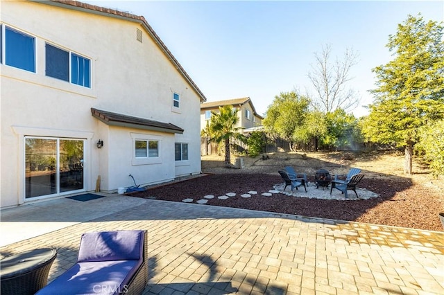 exterior space featuring a patio area and a fire pit