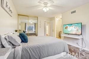 bedroom featuring ceiling fan and a closet