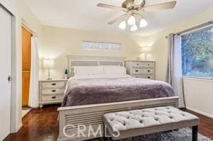 bedroom featuring ceiling fan, dark hardwood / wood-style floors, and a closet