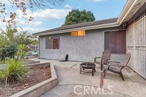 view of patio featuring an outdoor fire pit