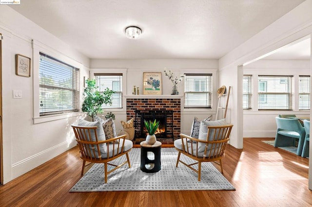 living area with a fireplace and hardwood / wood-style flooring