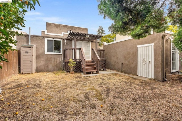 rear view of house featuring a pergola